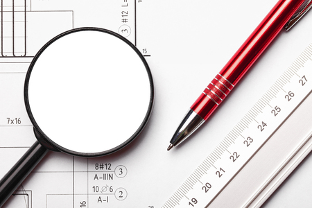 Top view engineering background. Silver ruler, red pen and empty copy space magnifying glass on white paper with project lines.の写真素材