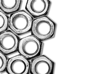 Gray metal nuts isolated on white with empty copy space industrial background.