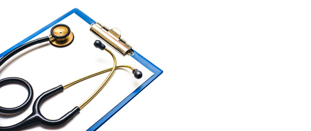 Stethoscope on clipboard with paper isolated on white. Horizontal medical copy space for graphiic design text.の写真素材