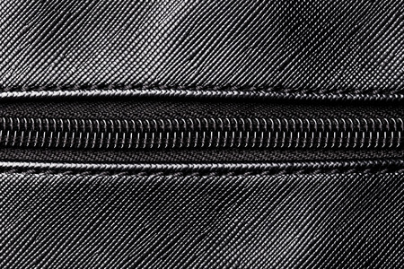 Artificial leather handbag texture. Black textile zipper background.の写真素材