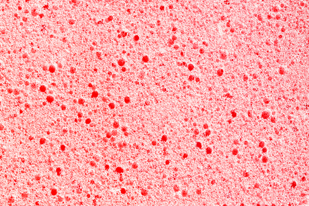 Red porous sponge foam structure. Plastic air bubble holes texture.の写真素材