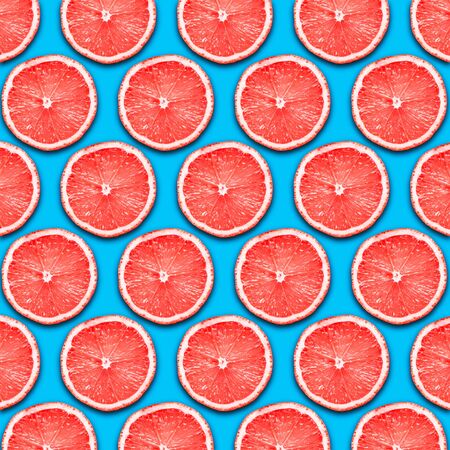 Red grapefruit slices design background.