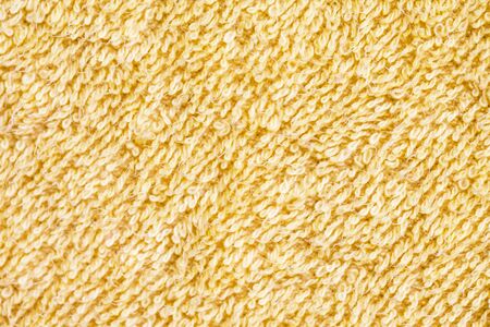 Soft yellow fluffy towel macro fabric texture.の写真素材