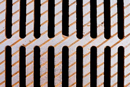 Metal drainage hole support beams pattern. Grunge industrial sewer grate texture.