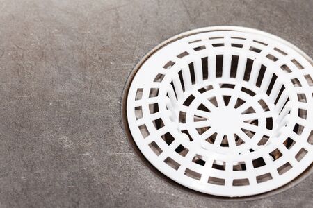 Metal kitchen sink. Plastic white sieve closeup empty copy space background.の写真素材