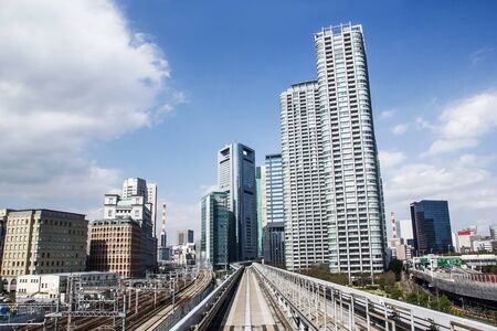 Tokyo sky train. Traveling over the city on railway. Japanese fast and comfortable train system in capital city. Futuristic cityscape background.のeditorial素材