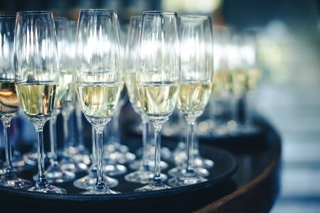 Tray of champagne glasses. Wedding party welcome table. New years eve alcohol celebration. Empty copy space event background.の写真素材