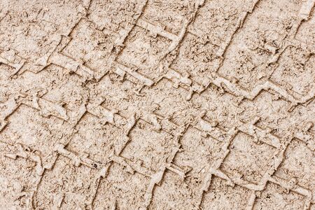 Mud tire mark background. Wet sand tire print texture. Car trail track pattern.