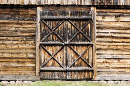 Grunge wooden barn door. Rustic vintage desk construction background. Countryside architecture...