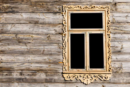 Wooden window background. Empty copy space rustic cottage house. Vintage cabin wall. Countryside architecture texture. Decorative wood carvings. Renovated building made of desks.の写真素材