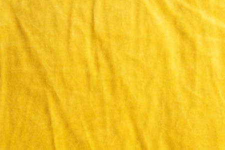 Yellow crumpled fabric texture. Color textile background.