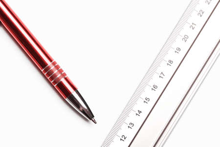 Engineering top view background. Silver ruler, red pen and empty copy space isolated on white paper. University project final paper. Architect job backdrop.の写真素材