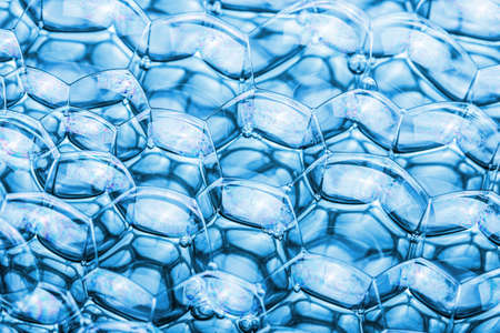 Water foam texture. Blue bubble spa background. Foam structure backdrop. Shapoo soap washing...