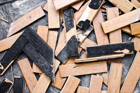 Home floor renovation. Old parquet demolition. Wooden floor panel removal. Apartment refreshing...