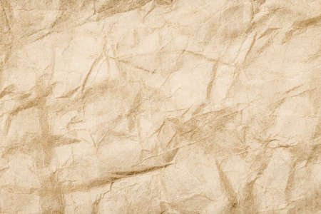 Brown crumpled paper texture. Grunge old parchment background. Stained dirty burned message backdrop...