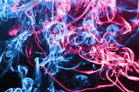 Blue and pink smoke background. Air gas swirl texture. Vapor isolated on black. Mist wave pattern....