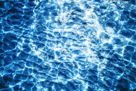 Sea wave background. Calm waves on shallow water. Ripples on lake water. Blue lake surface texture. Outdoor summe ocean perspective backdrop.の写真素材