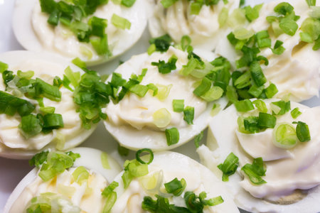 Eggs with mayonnaise. Hard boiled eggs with fresh chopped chives. Mayo eggs background. Tasty party snack.の写真素材