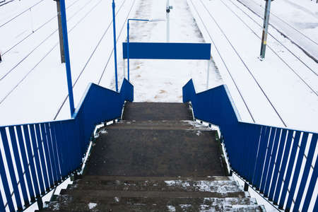 Railway top view background. Train track texture. White transportation background. Winter landscape. Snow on the railway. Icy train plaftorm. Train station covered in snow.の写真素材