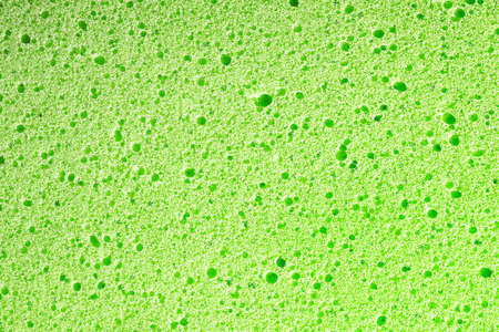 Sponge background. Closeup sponge texture. Green porous foam structure. Plastic air bubble holes texture.の写真素材