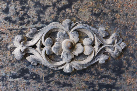 Metal flower ornament. Iron decorative texture. Black smith work background. Rusty metal background. Black steel corroded flower shape.の写真素材