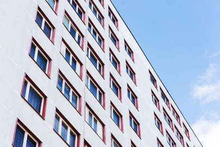 Bialystok city in Poland architecture background. High block of flats skyscraper living area. Old neighborhood retro style. Metal sheet cladding. Sunny balcony apartments.の写真素材