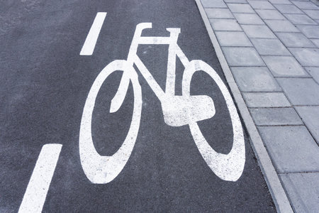 Bicycle lane background. Asphalt road for bikes. White paint bicycle painted on street. Pavement and bicycle lane. Walking and cycling path.の写真素材