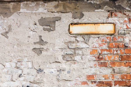 Street name sign. Empty copy space. Blank metal text place. Rusty urban background. Brick wall texture. Vintage city building.の写真素材