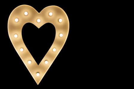 Heart shape isolated on black. Light bulbs in heart shape frame. Love lamp symbol. Glowing electric love. Wedding dance floor decoration in dark.の写真素材