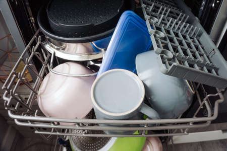Inside dishwasher view. Washing dishes background. Full shelf with load of glassware.の写真素材