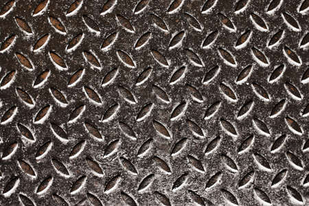 Metal sheet with rhombus pattern as background, closeup viewの写真素材
