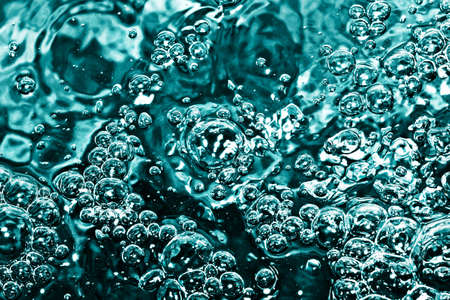 Blue water with bubbles. Abstract background of water with air bubbles.の写真素材