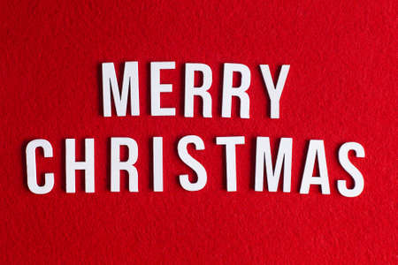 Merry Christmas white lettering on red background. Top view.の写真素材