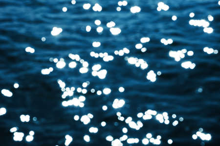 Abstract background of water surface with bokeh defocused lights.の写真素材