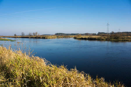 Autumn river landscape. Water flow background. Countryside winter scenic view.