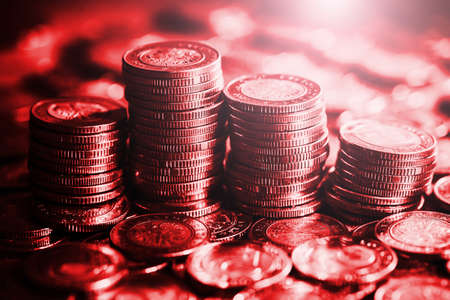 Stacks of coins on a red background. Business and finance concept.の写真素材