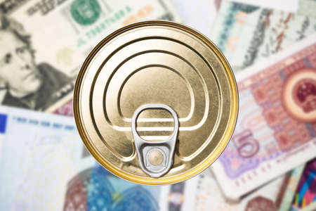 Top view of a tin can on a pile of banknotes.の写真素材