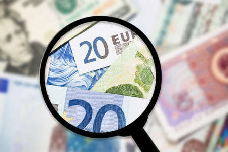 Money under a magnifying glass. Close-up. Business concept