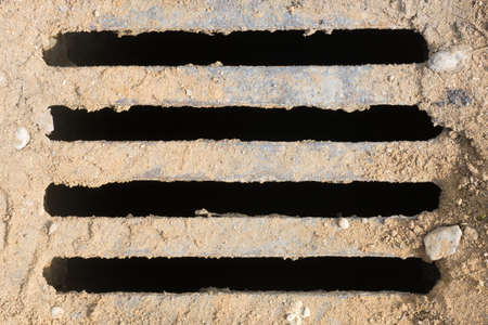 Drainage hatch on the ground. Close up. Background.の写真素材