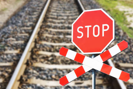 Stop sign on railroad tracks, closeup. Concept of restriction of movementの写真素材