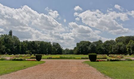 the big park with gravel road and grass, flowers and moreの写真素材