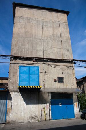 the old factory metal door with concrete wall の写真素材