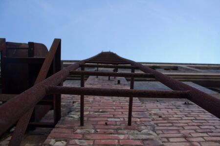 the very old ladder on the brick wallの写真素材