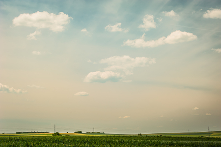 landscape with clouds and fieldsの写真素材