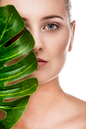 Woman beauty portrait with tropical leafの写真素材