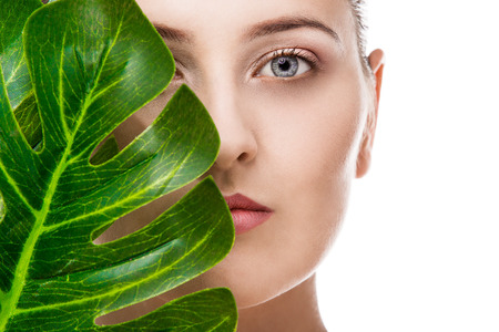 Woman beauty portrait with tropical leafの写真素材