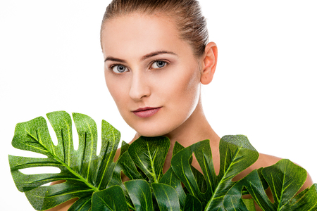 Woman beauty portrait with tropical leafの写真素材