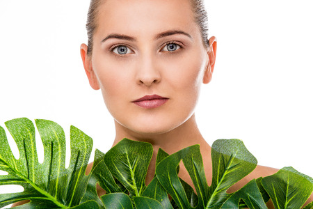 Woman beauty portrait with tropical leafの写真素材