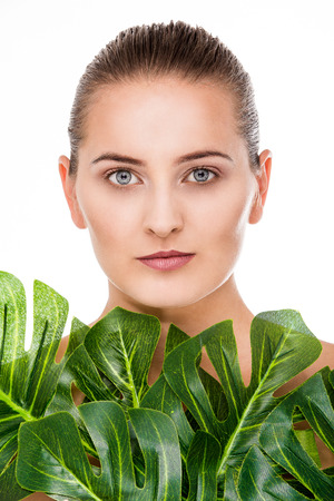 Woman beauty portrait with tropical leafの写真素材