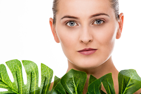 Woman beauty portrait with tropical leafの写真素材
